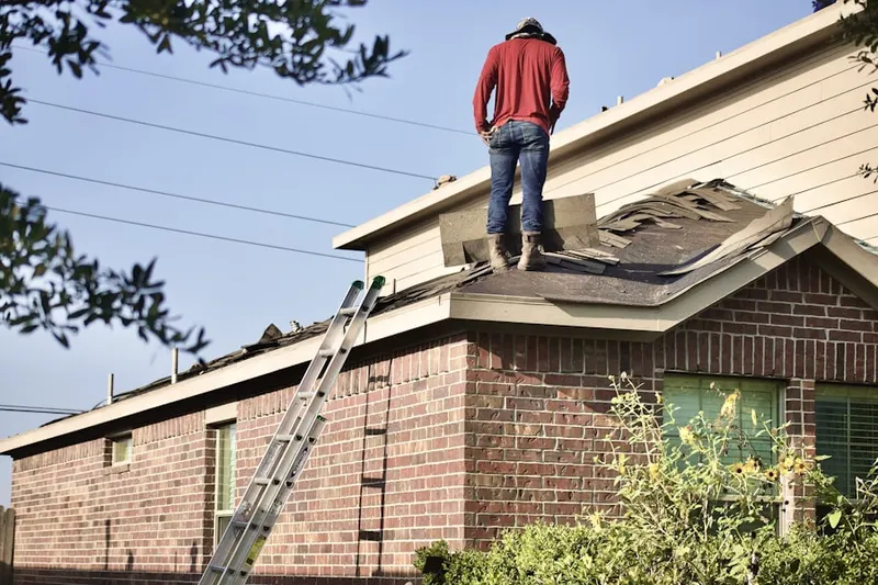 Professional roofer working on a residential roof in Colwich